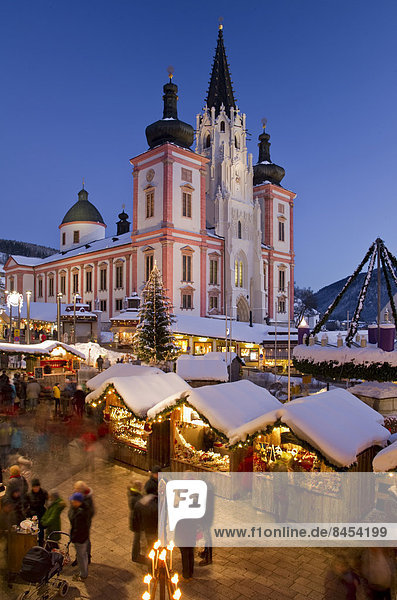 Christmas market in front of the Mariazell Basilica at the blue hour  main square  Maria Zell  Upper Styria  Styria  Austria