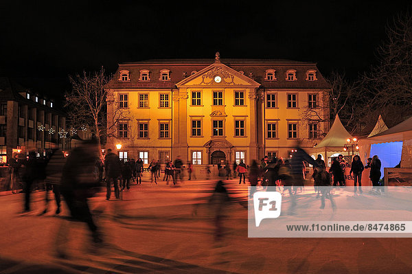 Skating rink with skaters on the market square at night  the Palais Stutterheim behind  Erlangen  Middle Franconia  Bavaria  Germany