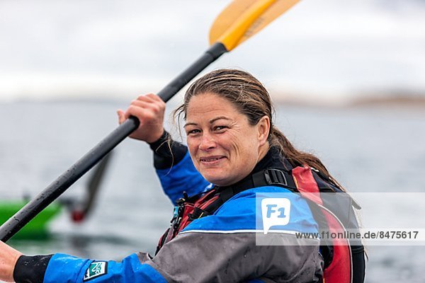 Smiling woman paddling  Fjallbacka  Bohuslan  Sweden