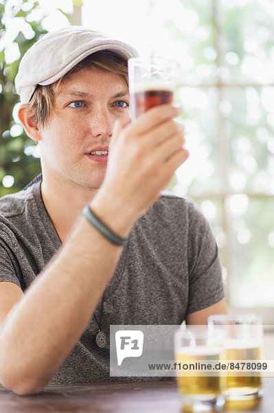 Man looking at glass of beer