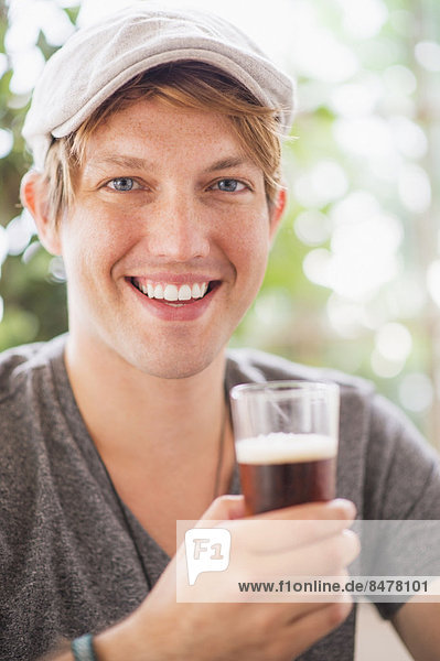 Portrait of man holding glass of beer