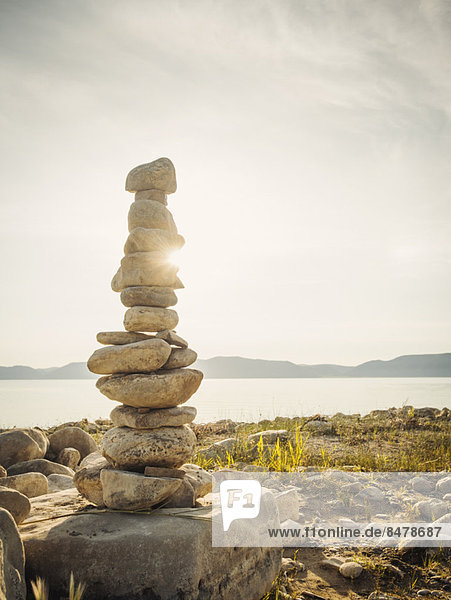 Stack of stones by lake