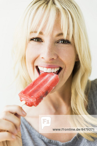 Woman eating ice popsicle