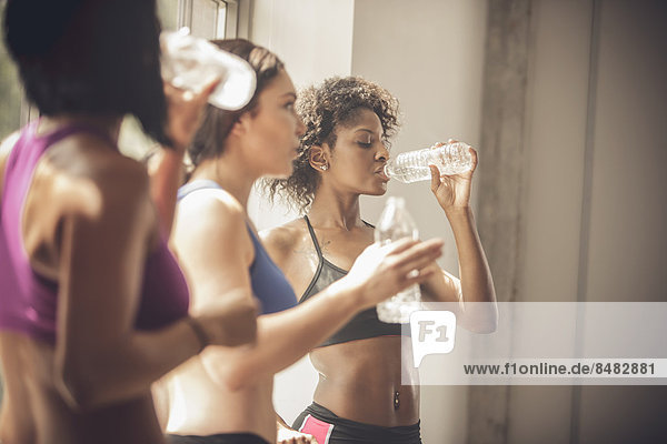Women drinking water in gym