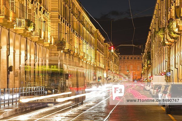 Via Po avenue lit up at night by passing traffic  Turin  Piedmont  Italy  Europe