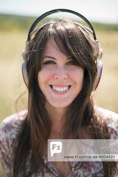 Portrait of mid adult woman wearing headphones