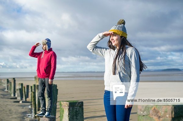 Young couple standing on groynes  Brean Sands  Somerset  England