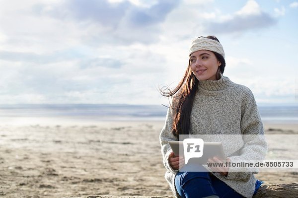 Young woman using digital tablet  Brean Sands  Somerset  England