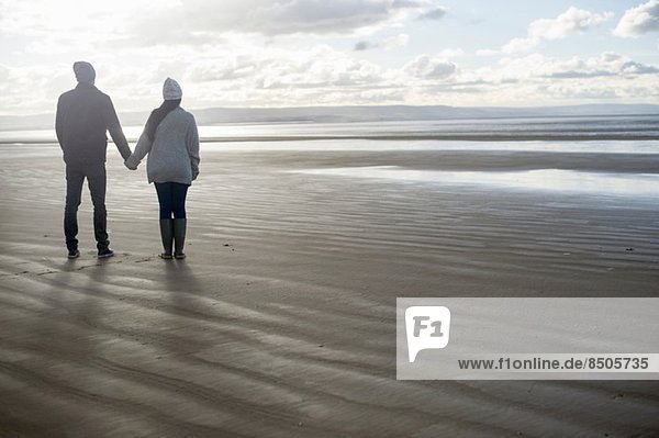 Young couple holding hands  Brean Sands  Somerset  England
