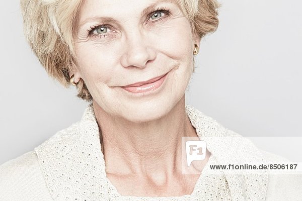 Cropped studio portrait of senior woman smiling