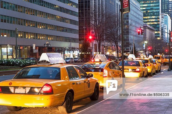 Row of yellow cabs next to sidewalk  New York  USA