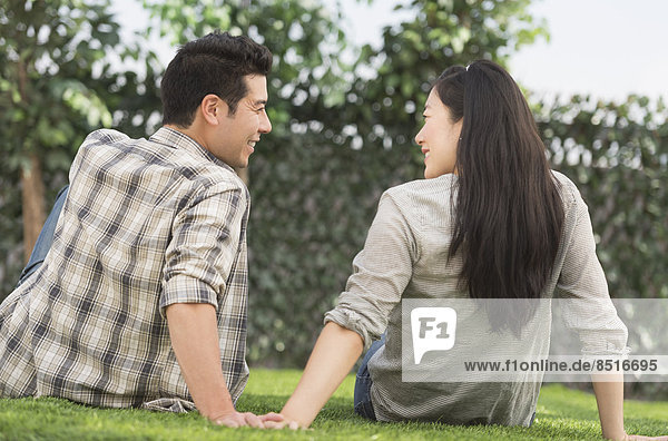 Couple relaxing together in grass