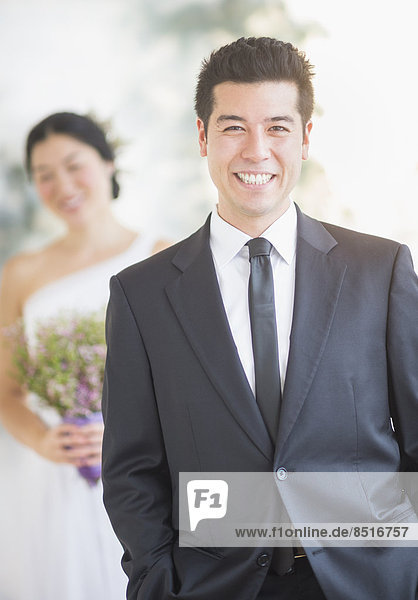 Newlywed groom smiling at wedding