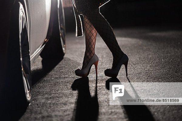 Eine Prostituierte steht an einer Strasse und wartet auf einen Freier.