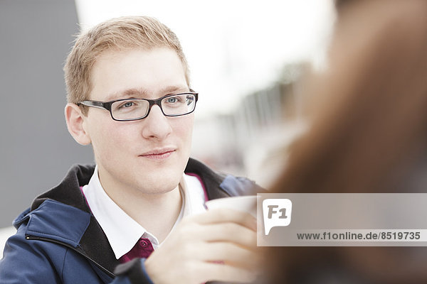 Young man with glasses outdoors