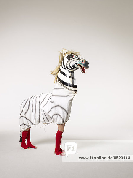 Two children inside zebra costume