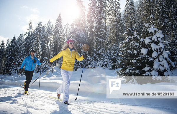 Austria,  Salzburg Country,  Altenmarkt-Zauchensee,  Young couple cross-country skiing