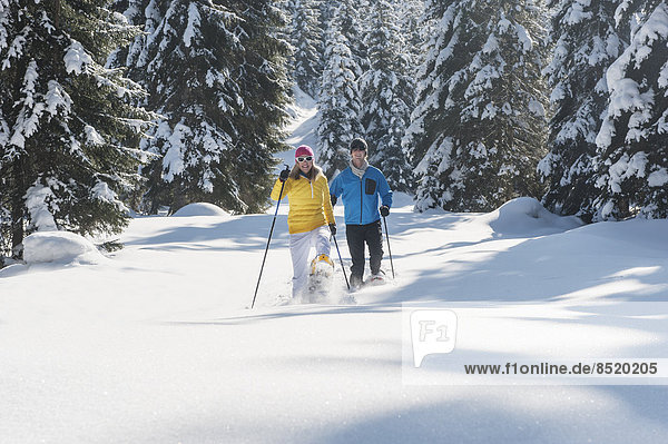 Austria,  Salzburg State,  Altenmarkt-Zauchensee,  Couple snowshoeing in winter landscape
