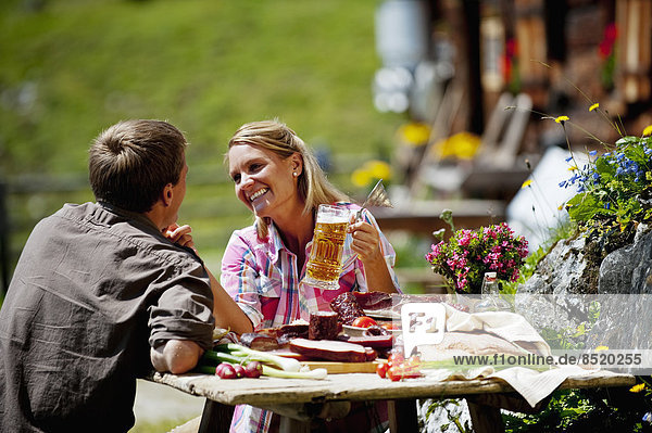 Austria  Salzburg State  Altenmarkt-Zauchensee  couple haßing an alpine picnic