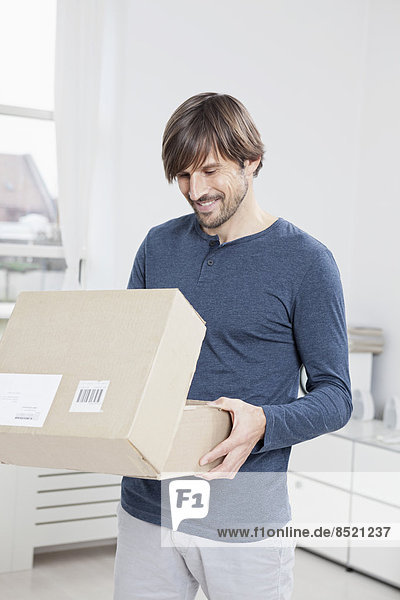 Man unpacking cardboard box