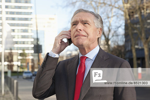 Portrait of telephoning senior business man
