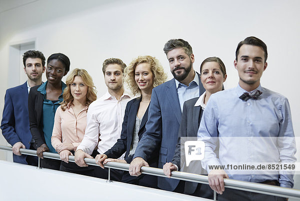 Germany  Neuss  Group of business people standing behind railing