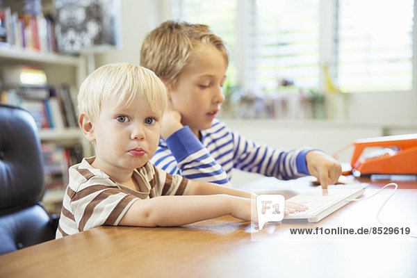 Children using computer together