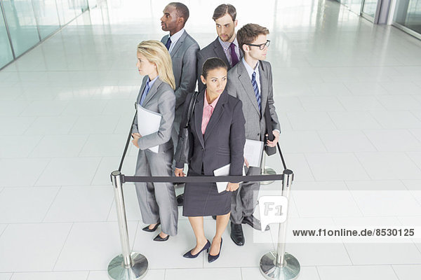 Business people standing in roped-off square