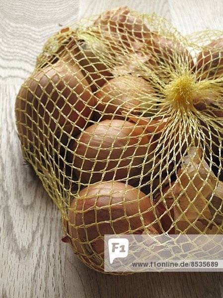 Brown onions in net