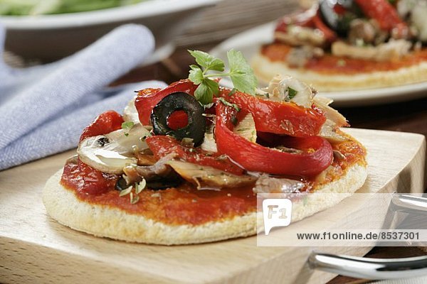 Mini pizza with peppers  mushrooms and olives