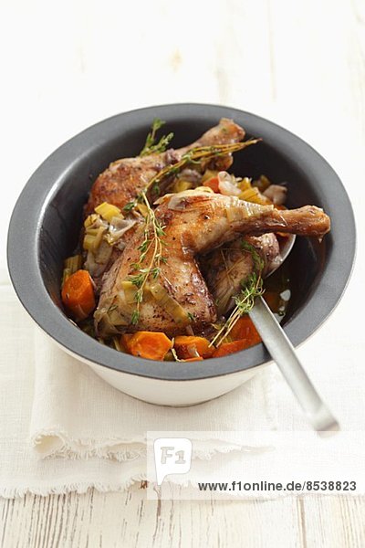Chicken legs braised in wine  with carrots and thyme