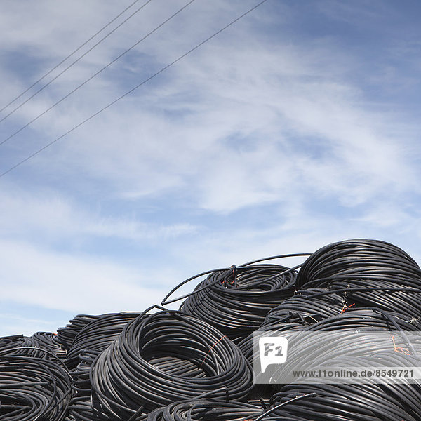 Heap of coiled plastic irrigation tubing.