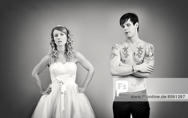 Wedding picture  bride and groom  bare chested groom with tattoos and a cigarette