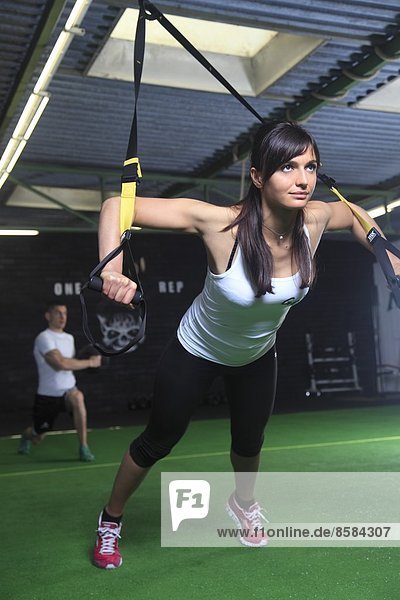 France  woman exercising in a crossfit gymnasium..
