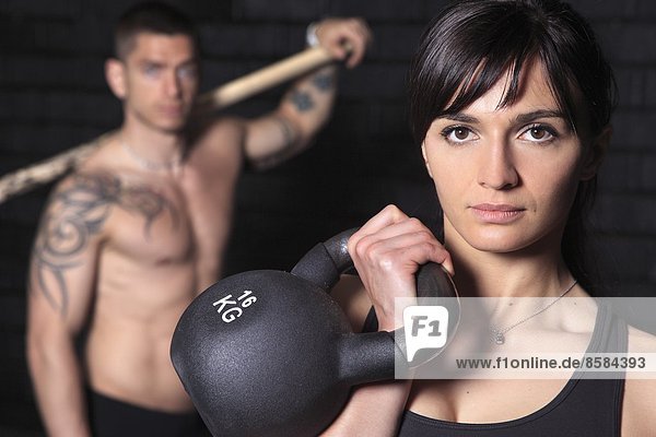 France  couple in crossfit gymnasium.