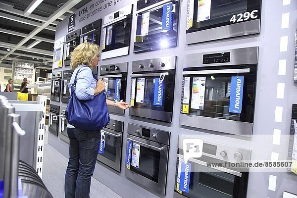 France  woman in the sector electric household appliances department of Ikea.