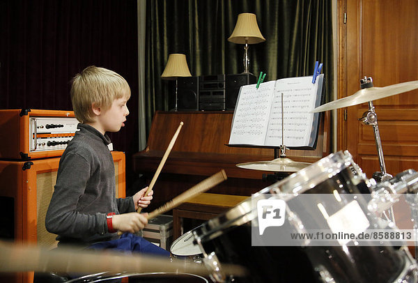 Seine et Marne. Little 9 year old boy during a particular music lessons (drums).