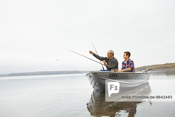 A day out at Ashokan lake. A man and a teenage boy fishing from a boat.