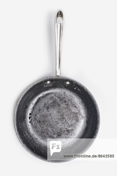 A well seasoned frying pan with a smooth cooking surface.