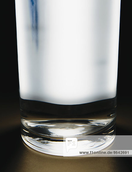 Light shining through glass of filtered water.