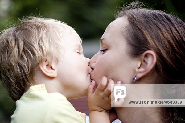 Mutter und Kleinkind küssen sich