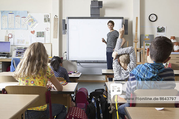 Teacher teaching to students in classroom