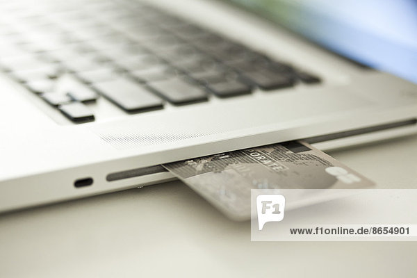 Credit card sticking out of side of laptop computer
