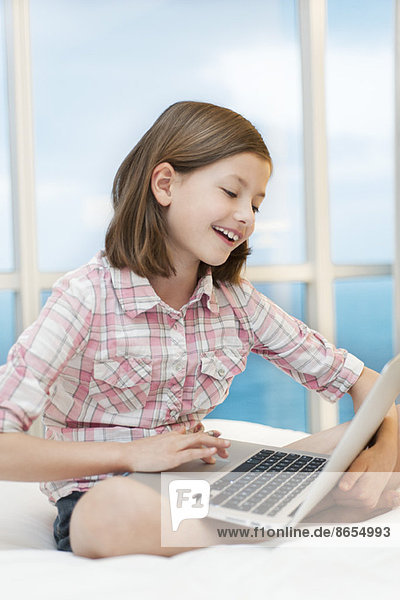 Girl using laptop computer  smiling