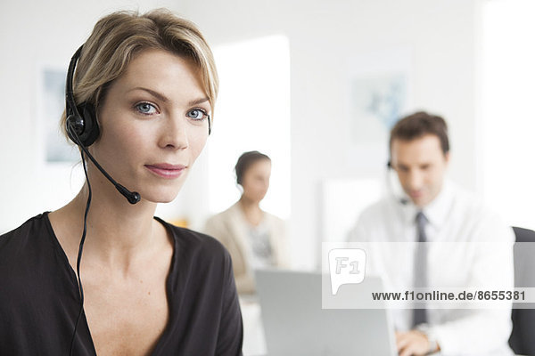 Businesswoman wearing headset working in office