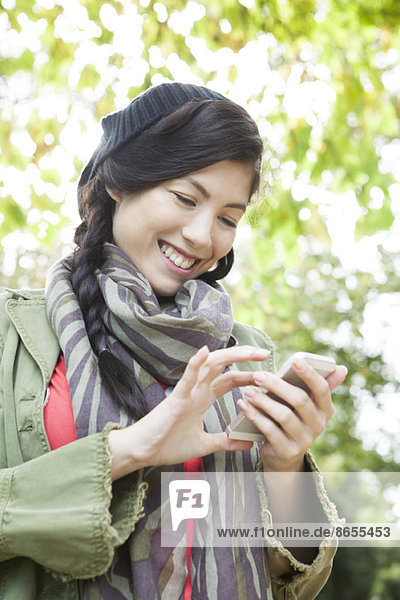 Young woman using smartphone outdoors