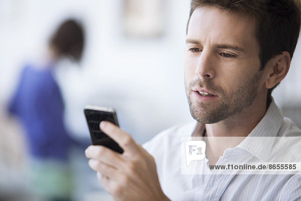 Mid-adult man checking cell phone