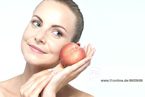 Young woman with peach