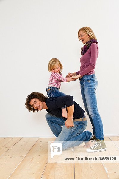 Studio shot of couple with young daughter