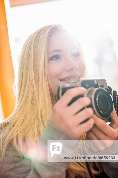 Teenage girl holding camera